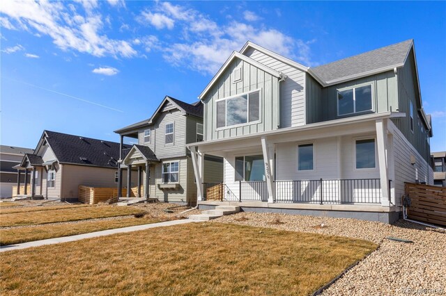 5271 Rendezvous Pkwy, Timnath, CO 80547 - view of front of home featuring board and batten siding, a porch, and a front yard