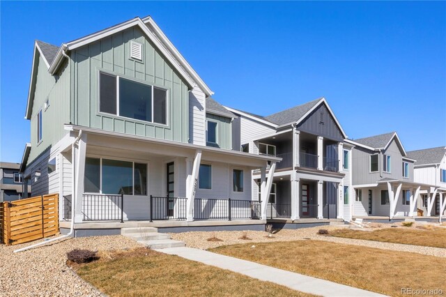 5271 Rendezvous Pkwy, Timnath, CO 80547 - modern inspired farmhouse with board and batten siding, a porch, and a front yard