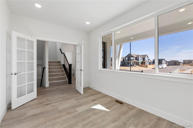 5271 Rendezvous Pkwy, Timnath, CO 80547 - basement featuring french doors, baseboards, stairway, light wood-type flooring, and recessed lighting