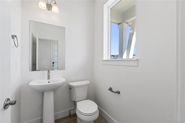 5271 Rendezvous Pkwy, Timnath, CO 80547 - half bath featuring toilet, baseboards, and wood finished floors