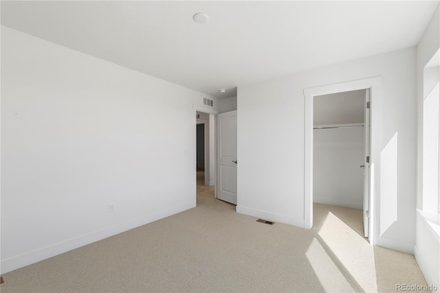 5271 Rendezvous Pkwy, Timnath, CO 80547 - unfurnished bedroom with light carpet, a closet, a spacious closet, and baseboards