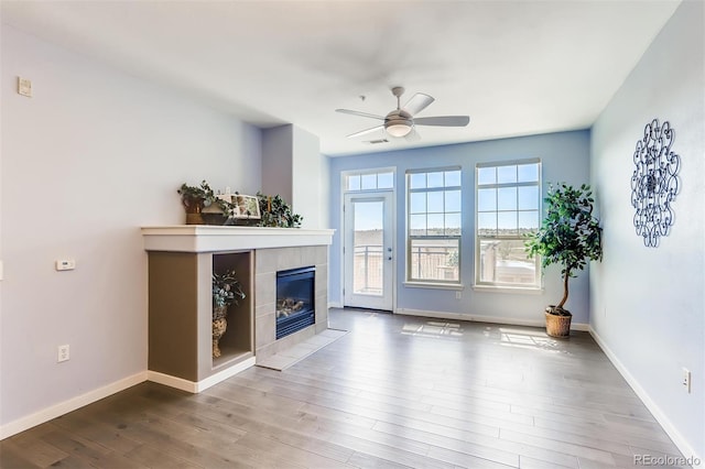 13456 Via Varra Unit 315, Broomfield, CO 80020 - living area featuring a ceiling fan, wood finished floors, a fireplace, and baseboards
