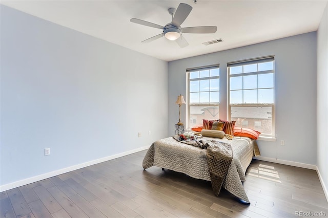 13456 Via Varra Unit 315, Broomfield, CO 80020 - bedroom with baseboards, wood finished floors, and ceiling fan