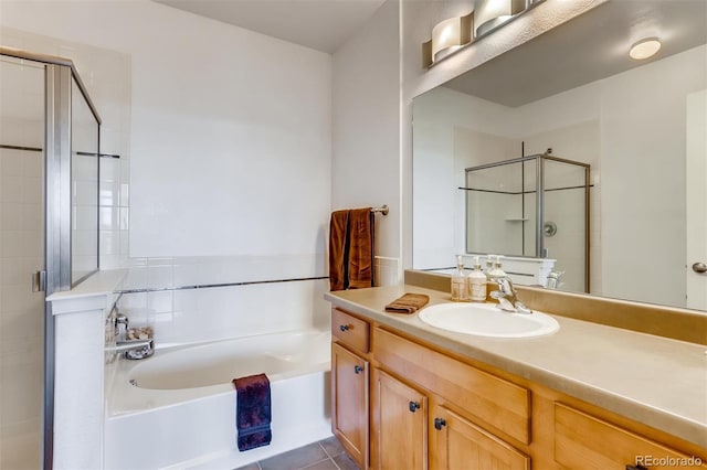 13456 Via Varra Unit 315, Broomfield, CO 80020 - full bathroom featuring a garden tub, a shower stall, vanity, and tile patterned floors