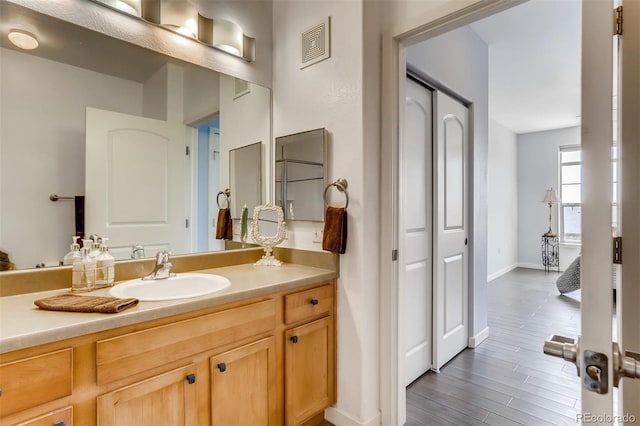 13456 Via Varra Unit 315, Broomfield, CO 80020 - bathroom with vanity, wood finished floors, and baseboards