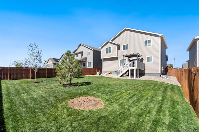 rear view of property featuring a pergola, a yard, and a wooden deck