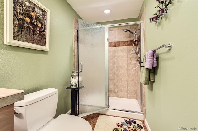 bathroom featuring a stall shower, toilet, tile patterned floors, recessed lighting, and baseboards