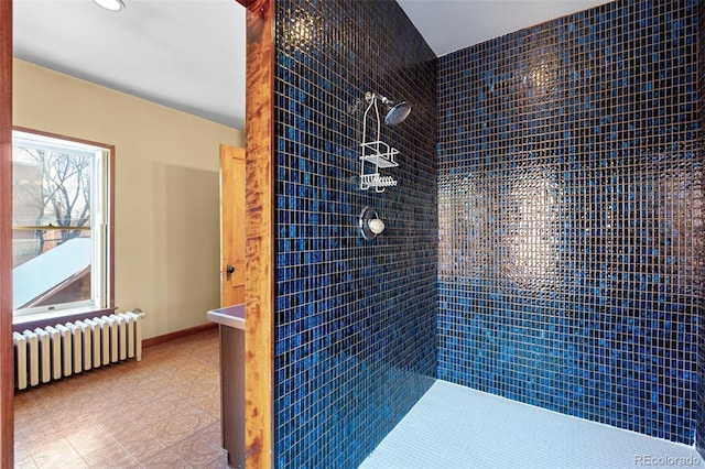 bathroom featuring a tile shower and radiator heating unit