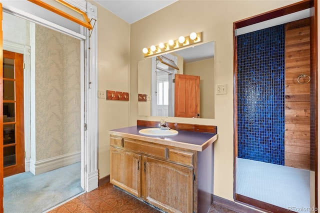 bathroom with vanity and a shower