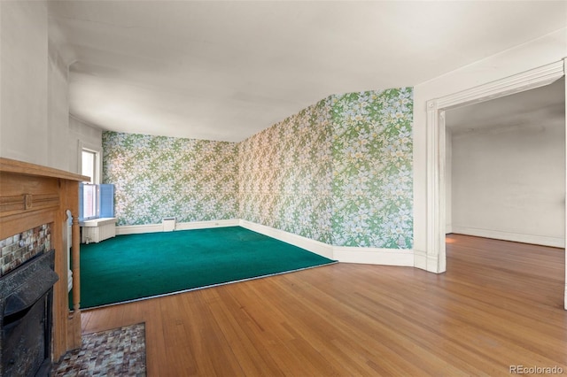 unfurnished living room with a fireplace and hardwood / wood-style floors