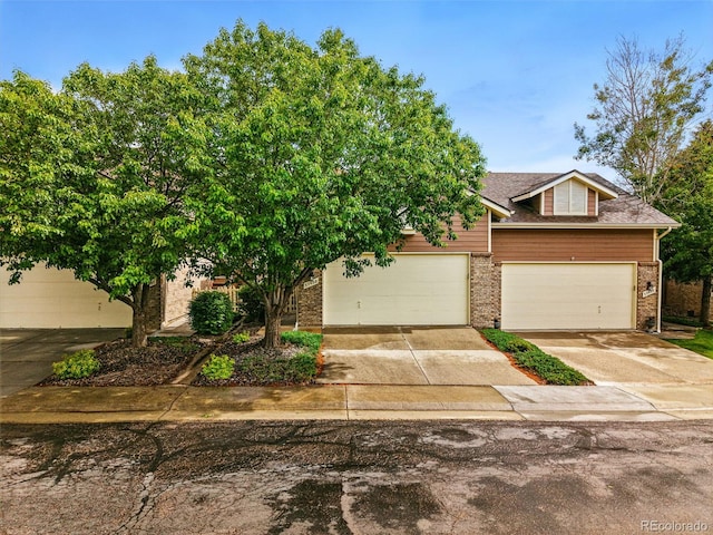 3240 W 114th Cir Unit D, Westminster, CO 80031 - obstructed view of property with brick siding and driveway