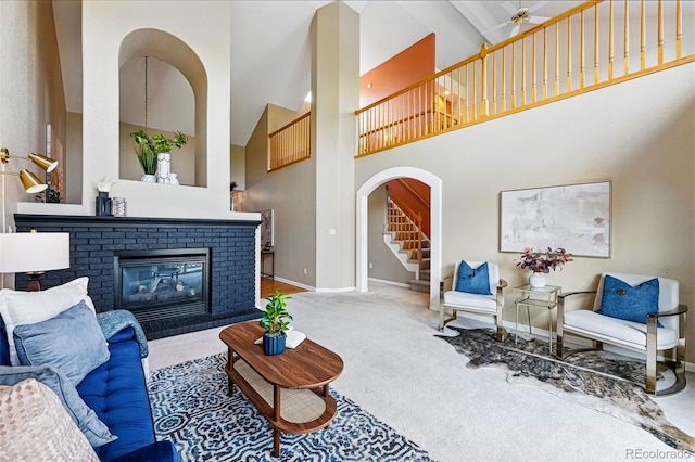 3240 W 114th Cir Unit D, Westminster, CO 80031 - living room with high vaulted ceiling, carpet flooring, baseboards, arched walkways, and a fireplace