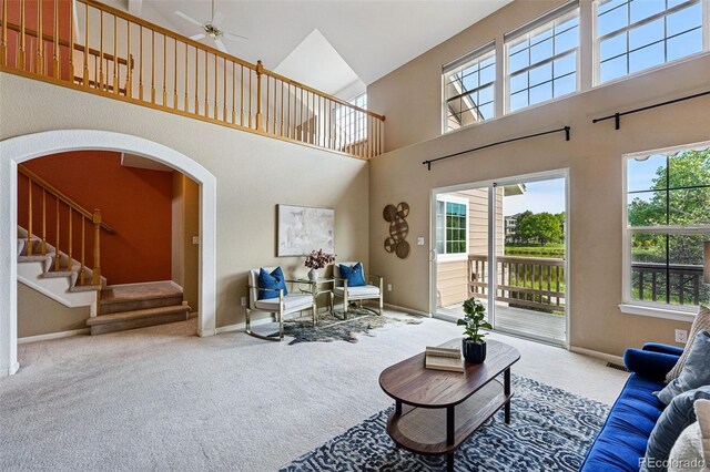 3240 W 114th Cir Unit D, Westminster, CO 80031 - carpeted living area with a high ceiling, healthy amount of natural light, a ceiling fan, stairway, and baseboards
