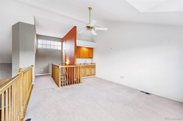 3240 W 114th Cir Unit D, Westminster, CO 80031 - unfurnished living room with light colored carpet, ceiling fan, and a sink