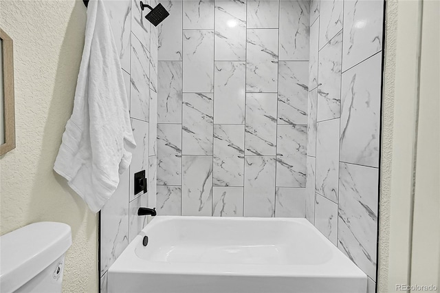 bathroom featuring toilet and tiled shower / bath combo