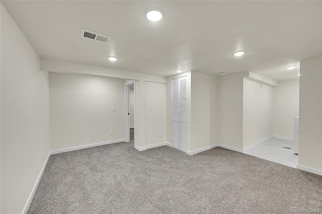 basement featuring light colored carpet