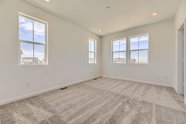 unfurnished bedroom featuring visible vents, baseboards, recessed lighting, and light colored carpet