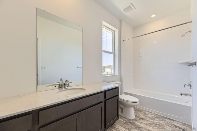 bathroom with shower / bath combination, visible vents, vanity, and toilet