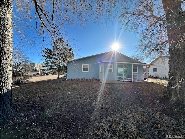 back of house with covered porch