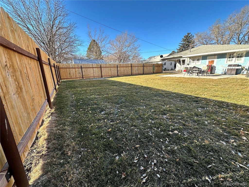 view of yard with a patio area and a fenced backyard