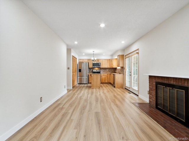 unfurnished living room featuring light hardwood / wood-style floors and a fireplace