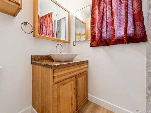 bathroom with vanity and wood-type flooring