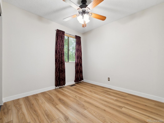 unfurnished room with a textured ceiling, light hardwood / wood-style flooring, and ceiling fan