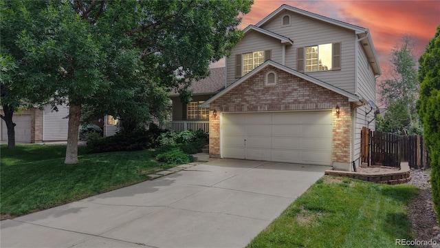 4164 E 135th Pl, Thornton, CO 80241 - view of front of home with concrete driveway, brick siding, and an attached garage
