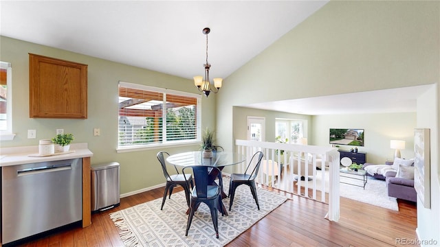 4164 E 135th Pl, Thornton, CO 80241 - dining room featuring wood finished floors, a chandelier, and high vaulted ceiling