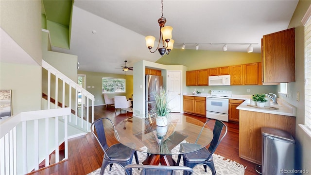 4164 E 135th Pl, Thornton, CO 80241 - dining space with vaulted ceiling, stairs, a chandelier, a ceiling fan, and wood finished floors