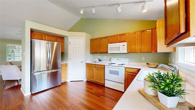 4164 E 135th Pl, Thornton, CO 80241 - kitchen with white appliances, track lighting, light countertops, healthy amount of natural light, and vaulted ceiling