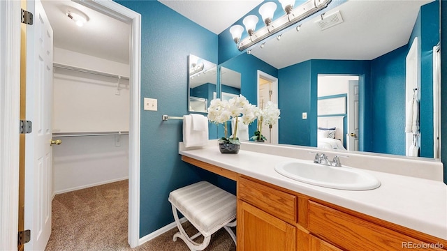 4164 E 135th Pl, Thornton, CO 80241 - bathroom featuring vanity and a walk in closet