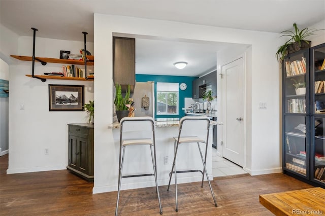 2870 Pontiac St, Denver, CO 80207 - kitchen featuring wood finished floors, baseboards, and freestanding refrigerator