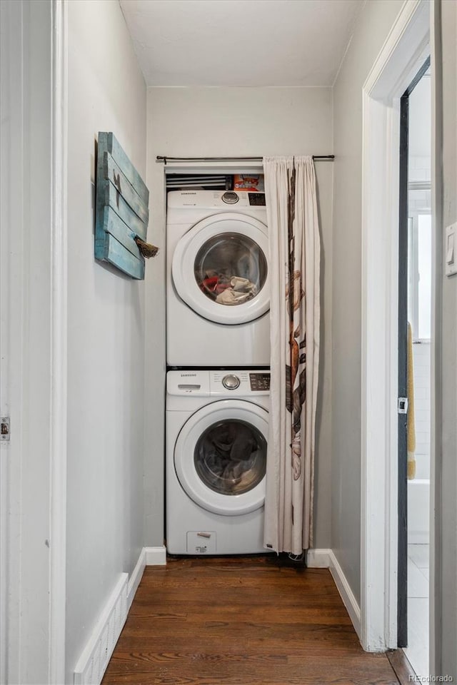 2870 Pontiac St, Denver, CO 80207 - laundry room with stacked washer and clothes dryer, wood finished floors, and baseboards