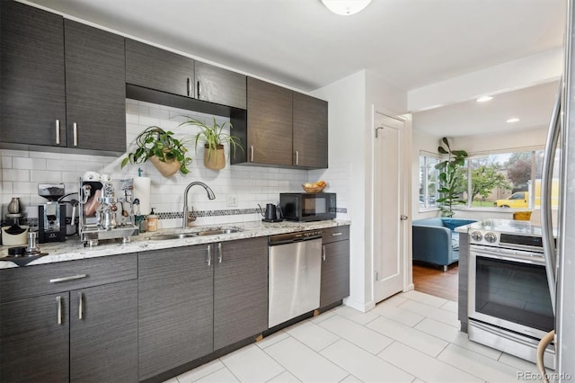 2870 Pontiac St, Denver, CO 80207 - kitchen with appliances with stainless steel finishes, a sink, decorative backsplash, light stone counters, and light tile patterned floors