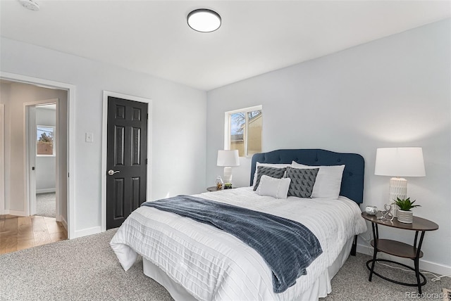 carpeted bedroom with baseboards