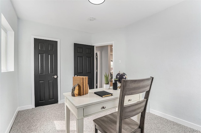 office space featuring baseboards and light colored carpet