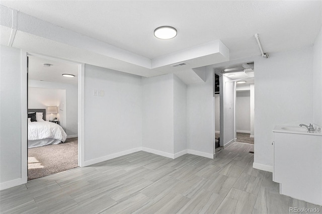 spare room with light wood-style flooring and baseboards