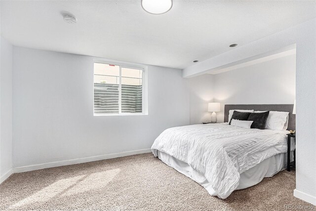 carpeted bedroom featuring baseboards