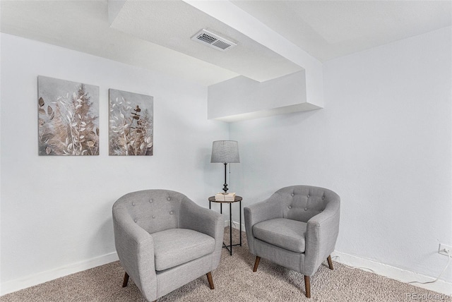 living area featuring carpet floors and baseboards