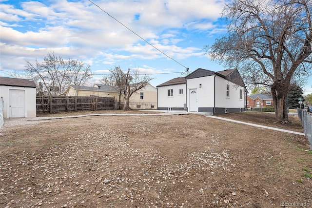rear view of house featuring fence and a residential view