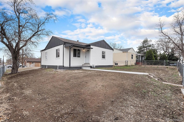 view of front facade featuring fence and board and batten siding