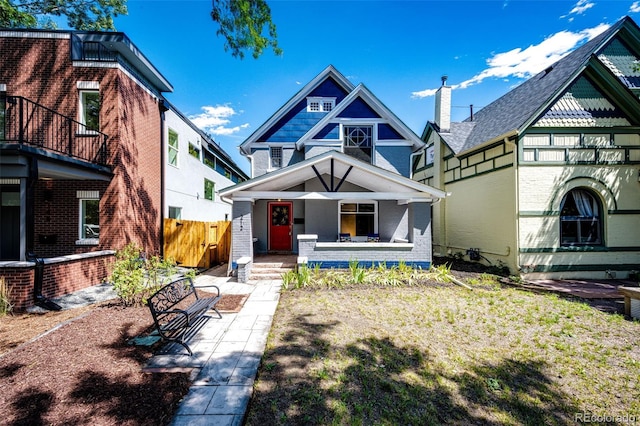 view of front of home featuring covered porch and a front yard