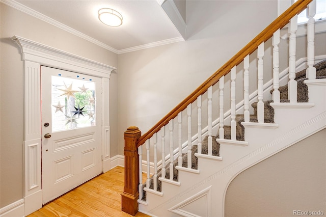 foyer featuring crown molding and hardwood / wood-style flooring