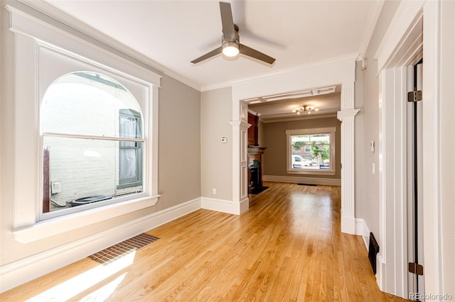 unfurnished room with ceiling fan, ornamental molding, and light wood-type flooring