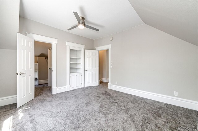 unfurnished bedroom featuring light carpet, lofted ceiling, and ceiling fan