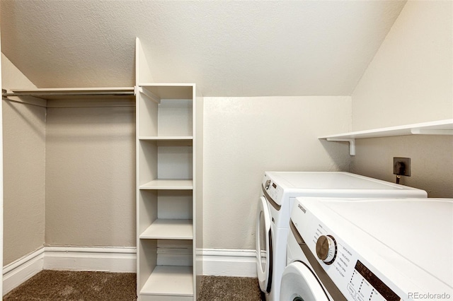 laundry room featuring washing machine and clothes dryer, a textured ceiling, and carpet floors