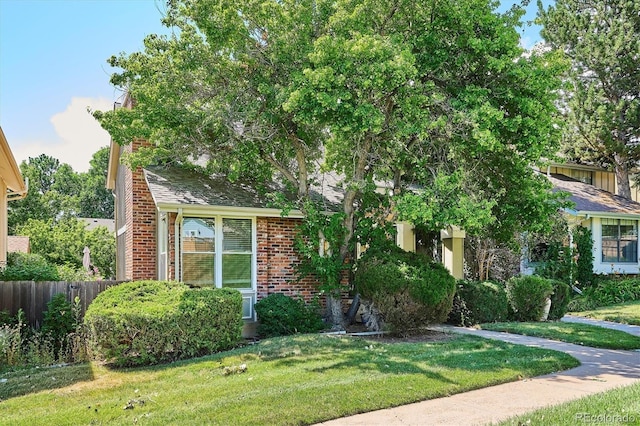 7713 E Jamison Dr, Centennial, CO 80112 - view of property hidden behind natural elements with brick siding and a shingled roof
