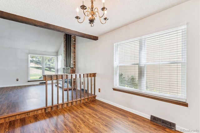 7713 E Jamison Dr, Centennial, CO 80112 - spare room with a chandelier, wood finished floors, and a textured ceiling