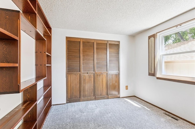 7713 E Jamison Dr, Centennial, CO 80112 - unfurnished bedroom with carpet flooring, a textured ceiling, and a closet